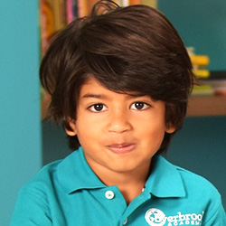 little boy sitting with a straight face