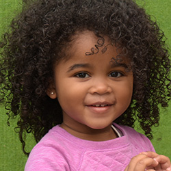 little girl smiling  at daycare