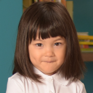 little girl smirking at the camera with her uniform on