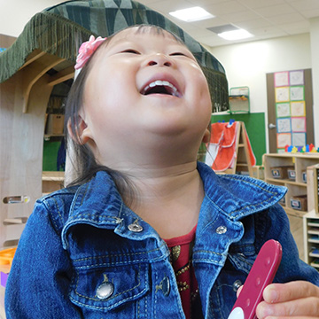 Content Page - 360x360 - Enrollment young girl laughing in classroom