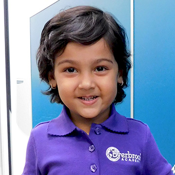 preschool aged girl posing for school picture 