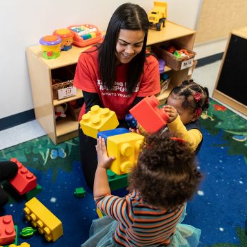 dropin teacher and children playing with legos