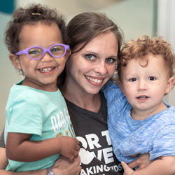 teacher and two students smiling